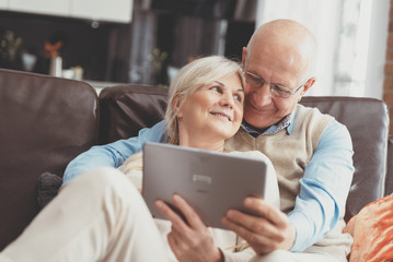 Grandparents using social media on tablet