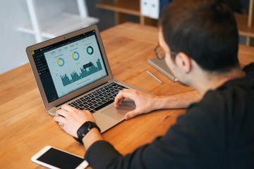 Closeup of man working on laptop with finances or ceo, graph, business analytics and strategy