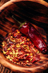 Ground red chili pepper in wooden bowl