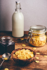 Breakfast with corn flakes, milk and jam