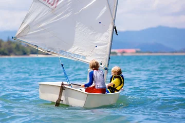 Fototapeten Child sailing. Kid learning to sail on sea yacht. © famveldman