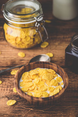 Breakfast with corn flakes, milk and jam