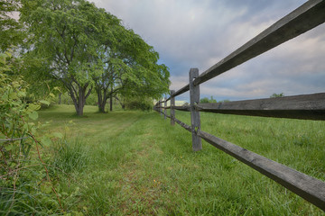 "Divided" a wooden fence dividing two rural country farms in the Blue Ridge Mountains ZDS Americana Fences Collection
