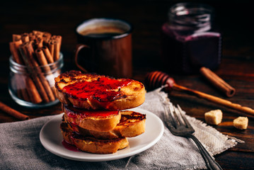 Stack of french toasts with berry syrup