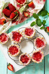 Berry mini pie summer. Sweet pie, tart with fresh berry strawberries. Delicious mini cake with strawberries. Top view flat lay background. Free space for your text.