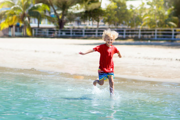 Kids playing on beach. Children play at sea.