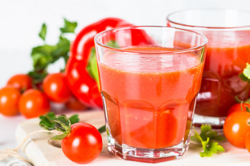 Fototapeta na wymiar Tomato vegetable juice in glass on white.