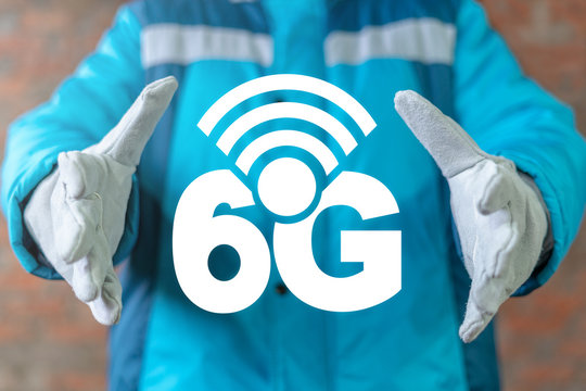 Industrial engineer uses on a virtual screen of the future and offers the icon: 6g radio waves. 6G Modern Industry High Speed Communication Technology.