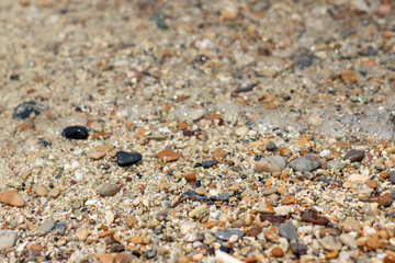 Stone gravel, beach area stone gravel several colors and coral fragments at have shape rounded round caused because of sea waves make give objects bump together all the time cause beauty naturally.