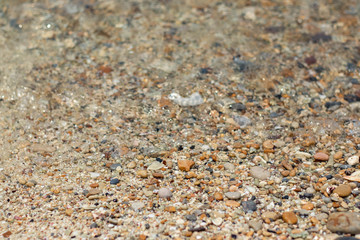 Stone gravel, beach area stone gravel several colors and coral fragments at have shape rounded round caused because of sea waves make give objects bump together all the time cause beauty naturally.