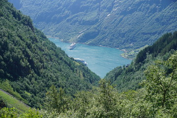 Obraz na płótnie Canvas Geiranger fjord with blue sky and with cruise liners in Norway