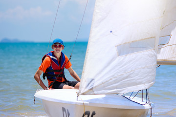 Man sailing. Boy learning to sail on sea yacht.
