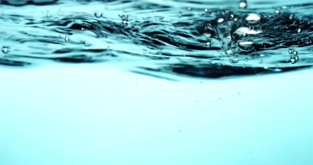 Blue acuatic scene with water surface and waves in upper section in 4K