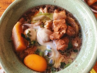Braised pork noodles with eggs on the hotpot in Thailand 