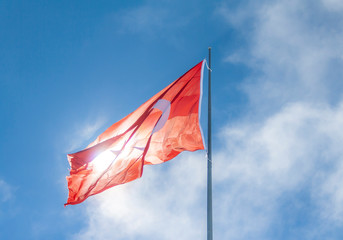 Turkish flag waving in cloudy blue sky. TURKEY