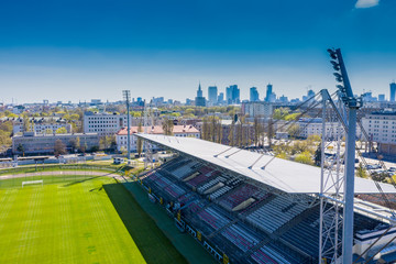 Aerial view of a football field captured by drone. Stadium lights