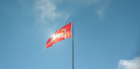 Turkish flag waving in cloudy blue sky. TURKEY