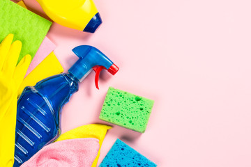Cleaning product, household on pink flat lay.