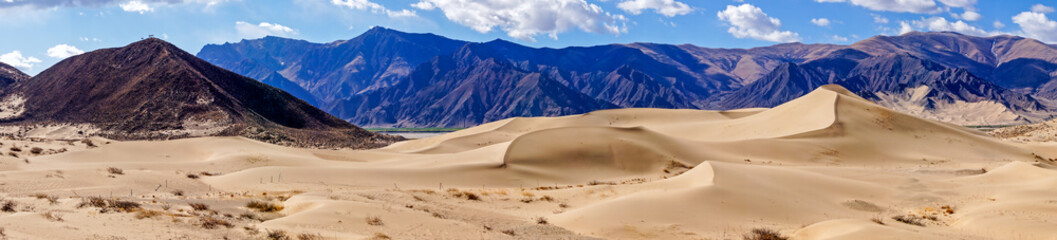 Fototapeta na wymiar Panoramic view of sand dunes in a desert area of the Tibetan Plateau near Samye Monastery - Tibet