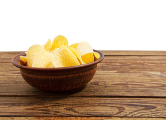 potato chips on empty wooden table isolated on white background copy space