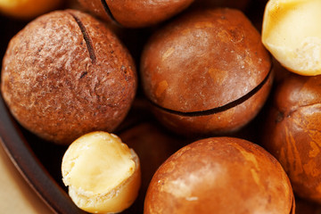Macadamia nut on wooden background with vintage cloth, concept of superfoods and healthy food