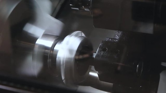 Hi-precision CNC milling machine bore cutting hole on steel parts with special tool in roughing process. Part molding process. Cutting metal modern processing technology. Close up