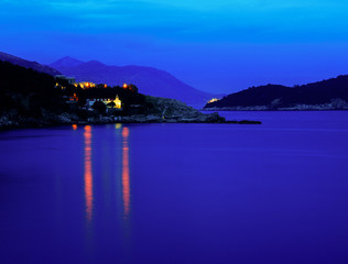 Moody landscape. Evening at the Mediterranean Sea with a view on the Dubrovnik lights, Lokrum island and distant mountains.