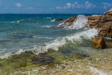 Waves breaking on a stony beach in Murter, Croatia, Dalmatia