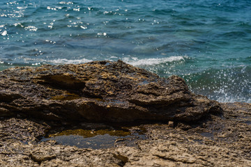 Waves breaking on a stony beach in Murter, Croatia, Dalmatia