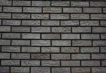 white wall of bricks with a gray tint brick background