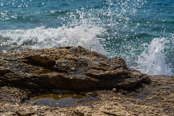 Waves breaking on a stony beach in Murter, Croatia, Dalmatia