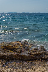 Waves breaking on a stony beach in Murter, Croatia, Dalmatia