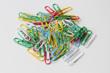 Colored stationery on a white background in one pile, high contrast, bright colors, random...