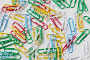 Colored stationery on a white background in one pile, high contrast, bright colors, random...