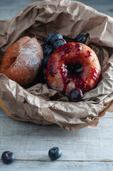 cheese donuts paper wrapper. on a wooden board.