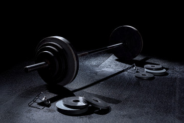 365 pound weight on barbell with weights on floor and collars in dramatic lighting in gym - 264255404
