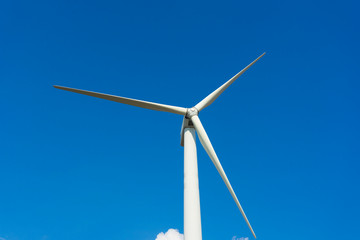 wind turbine against blue sky.