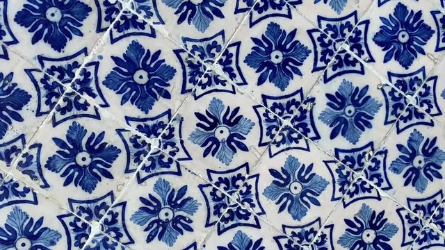 Abstract rotating background of painted ceramic tiles in blue and white