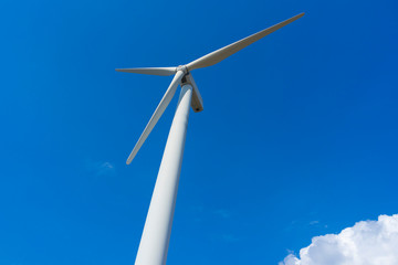 wind turbine against blue sky.