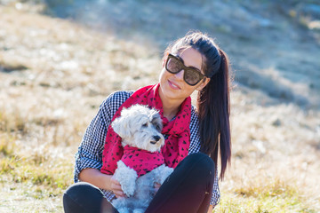 Beautiful Smiling Woman Hugging  Her Cute Havanese Dog with Red Scarf .Fashion for Owner and Dog .
