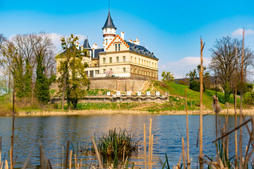Fototapeta na wymiar Renaissance old castle Radun near Opava city mirrored in a lake with reflections in water, Czech Republic