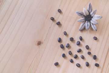 Close up of Coffee beans on wood background in vintage tone color style, selective focus (detailed close-up shot)