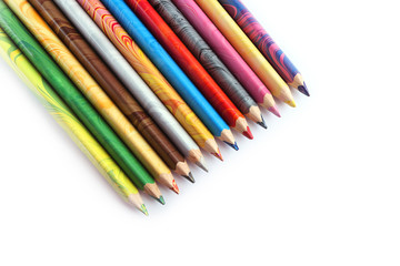 Color pencils on a white background. Spectrum of a rainbow. Back to school. Selective focus, close-up.