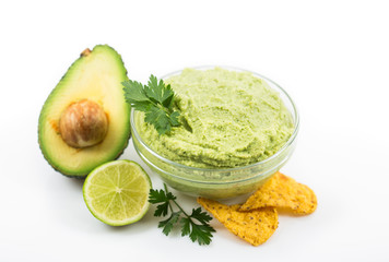 Homemade guacamole dip in the bowl on the white background