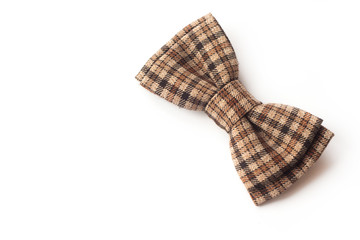Brown checkered bow tie on a white background. Men's and women's accessories. Hipster style