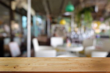 Empty dark wooden table in front of abstract blurred bokeh background of restaurant . can be used for display or montage your products.Mock up for space.