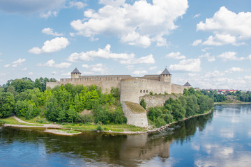 Fototapeta na wymiar Ivangorod fortress on the Bank of the Narva river in the summer noon