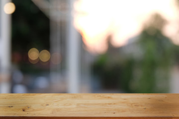 Empty dark wooden table in front of abstract blurred bokeh background of restaurant . can be used for display or montage your products.Mock up for space.