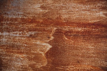 Oxidized iron panel. Texture or background. Rusty metal wall, old iron sheet covered with rust and corrosive paint.