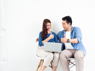 Asian Man and Woman talking with laptop computer for business on white background